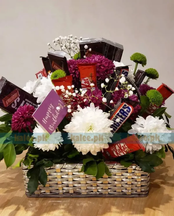 Chocolates basket adorned with white, green, and maroon daisies and baby's breath