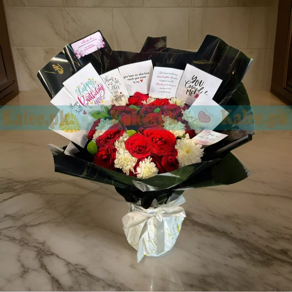 A bouquet with white daisies and red roses.