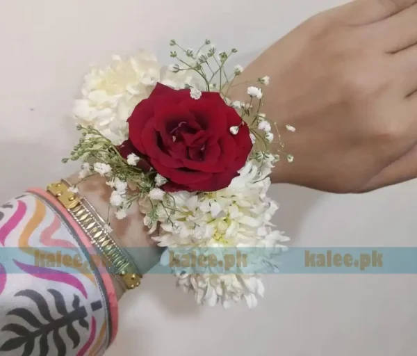 Red Rose Kangan With Baby Breath flowers arranged on a silver bangle