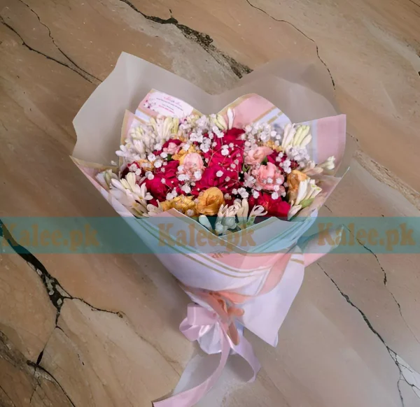 A bouquet of red, yellow, and pink roses with baby's breath.