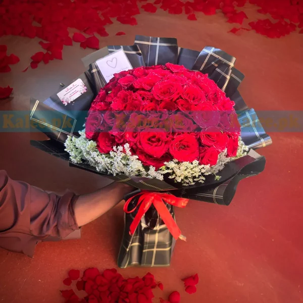 A bouquet of red roses with lacy accents.