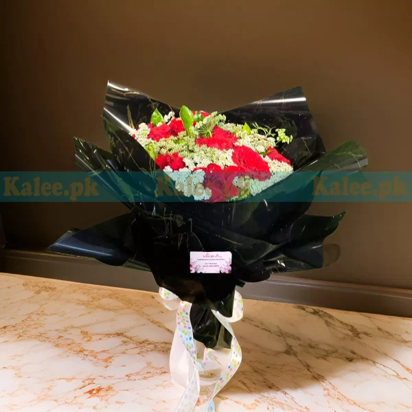 A classic design bouquet of red roses with lacy accents.