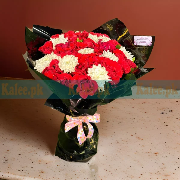 A bouquet of red roses and white daisies.