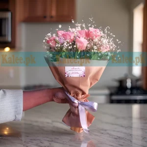 A bouquet with pink roses and baby's breath.