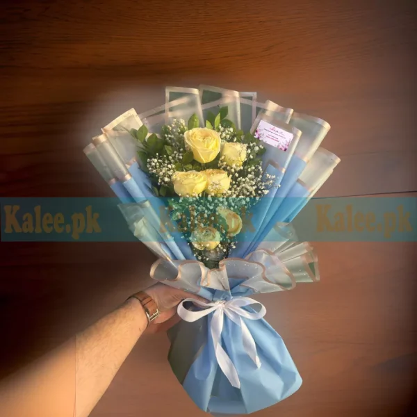 A bouquet with baby's breath and yellow roses.