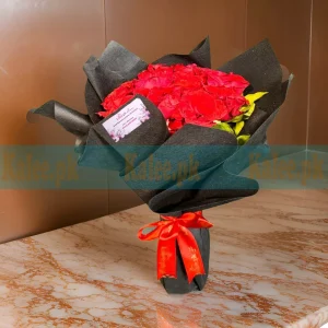 Dark-themed Flowers Bouquet with deep red roses, wrapped in elegant black paper and finished with a satin ribbon.