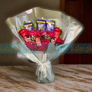 A bouquet with red roses, baby's breath, and chocolates.