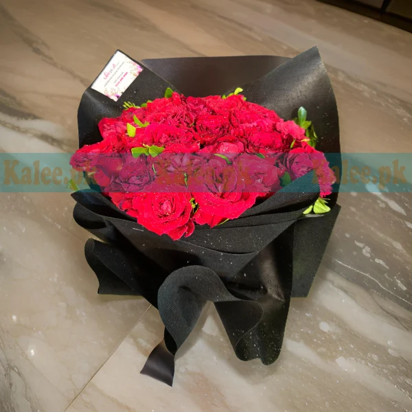 A classy bouquet of English red roses wrapped in elegant packaging.