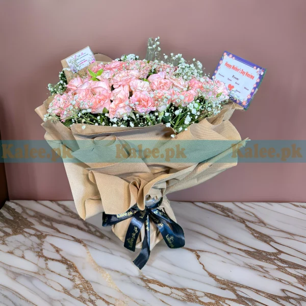 A stylish bouquet with pink roses and baby's breath.