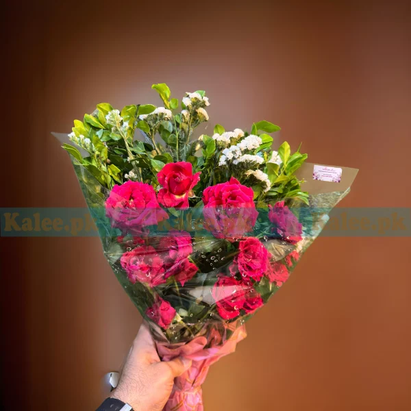 A bouquet of English red roses and statice.