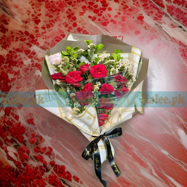 A bouquet of English red roses and statice.