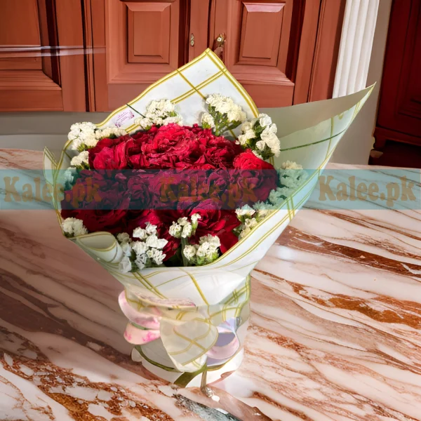 Bouquet of Red Roses with statice flowers, beautifully wrapped in decorative paper and finished with a satin ribbon.