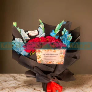 A hot bouquet with black shiny red roses and glades.