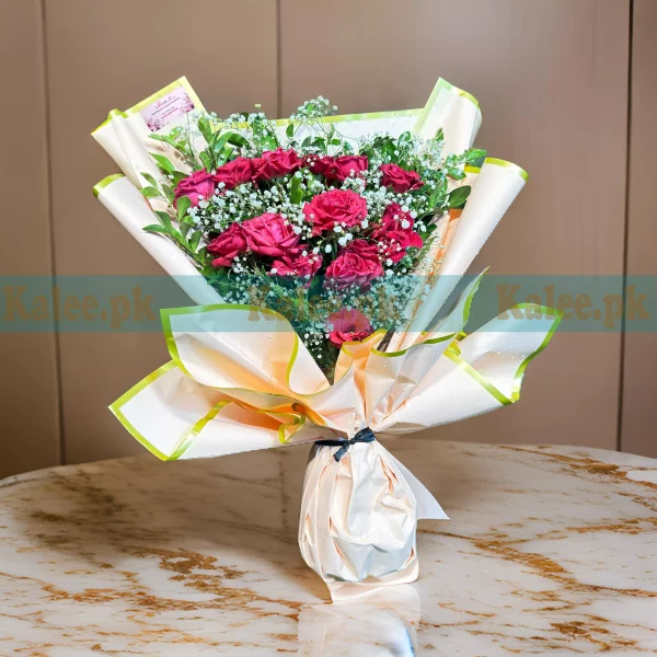 A bouquet with red roses and baby's breath.