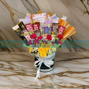 A box containing chocolates and mixed flowers.