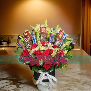 A Flowers Box with mixed flowers, baby's breath, and chocolates.