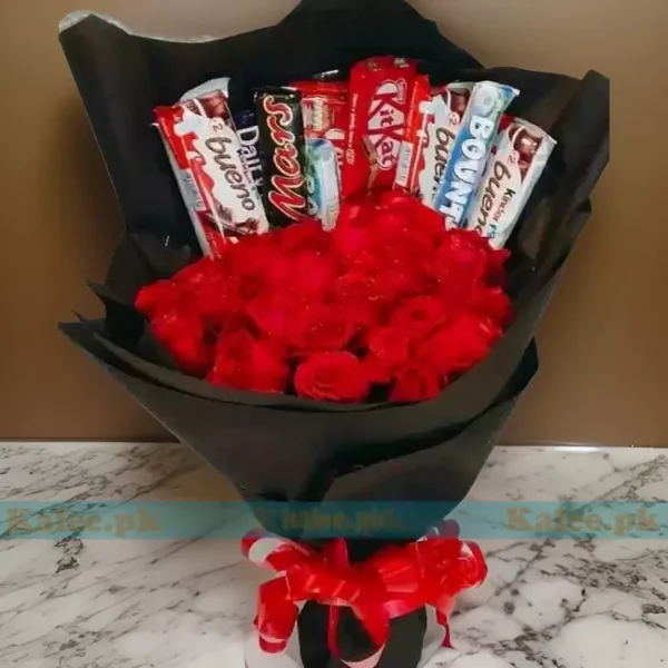 A bouquet featuring luscious chocolates intertwined with vibrant red rose flowers