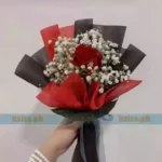 Single Red Rose bouquet with fresh baby’s breath, wrapped in decorative paper and finished with a satin ribbon.