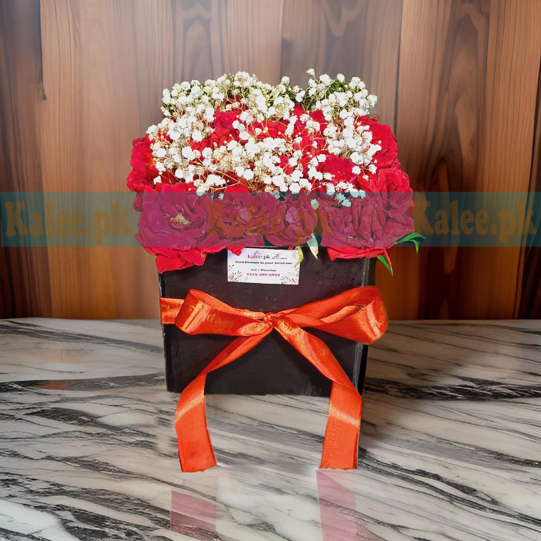 A beautiful box arrangement featuring English red roses and delicate baby's breath, creating an elegant and romantic floral gift.