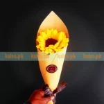 A single sunflower presented in chic and stylish wrapping.