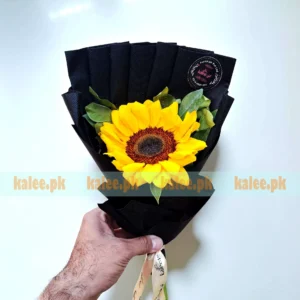A single sunflower beautifully wrapped in classic paper.
