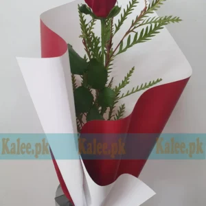 A single red rose elegantly wrapped in classy packaging.