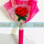 A single red rose delicately wrapped in vibrant colorful plastic.