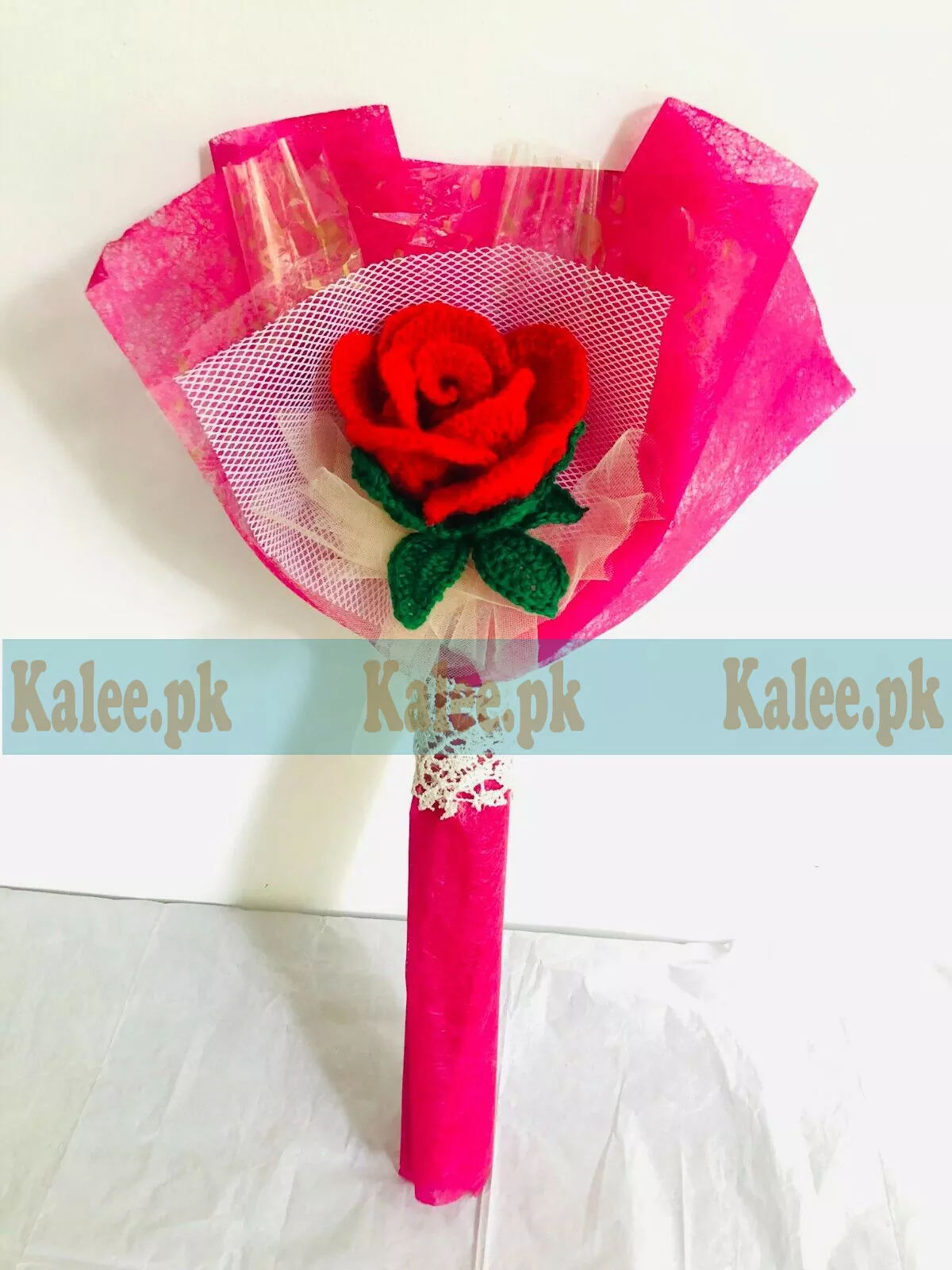 A single red rose delicately wrapped in vibrant colorful plastic.