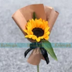 A single sunflower creatively wrapped with artisanal flair.