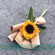 A single sunflower presented in a regal arrangement.