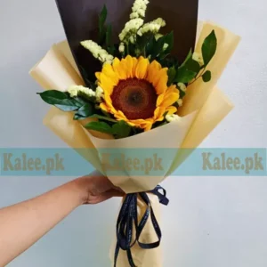 A single sunflower delicately wrapped in elegant paper.