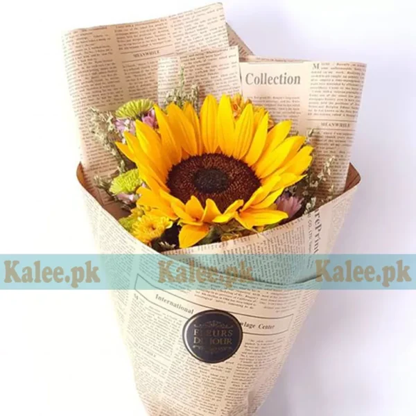 A vibrant sunflower wrapped in brown paper.