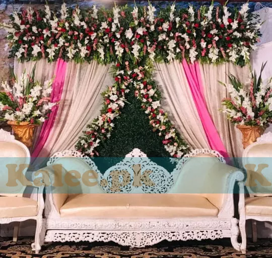 Stage adorned with white glades and red rose flowers decoration