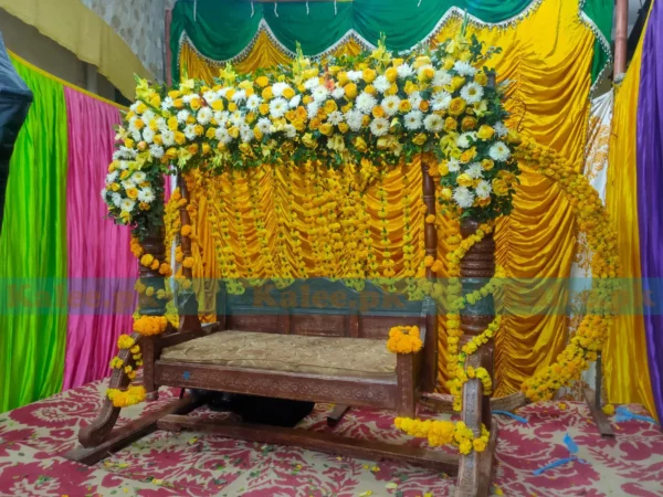 Stage adorned with glades, marigold, and white flowers