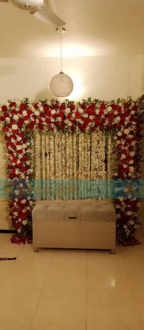 Stage adorned with white and red flowers