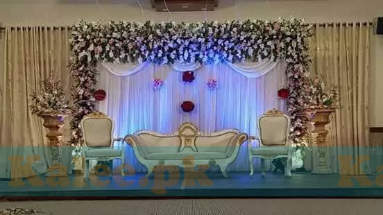 Wedding stage adorned with white glades