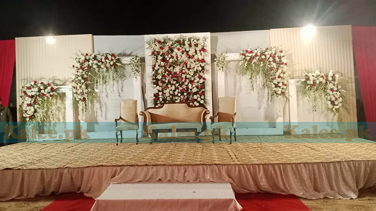 Stage adorned with glades and red rose flowers