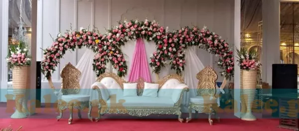 Stage adorned with glades and pink rose flowers