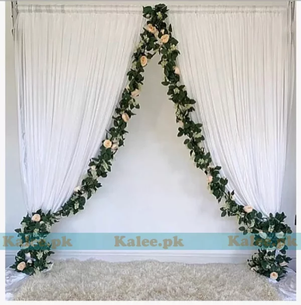 Stage adorned with creamy white rose flower decoration