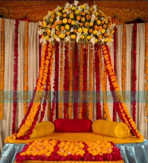 Stage adorned with marigold, tuberose, and rose flowers decoration