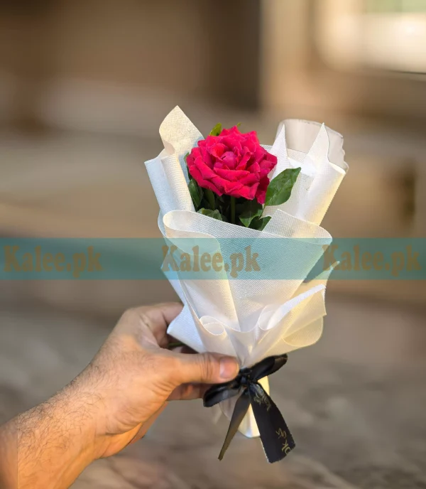 A single red rose with stylish wrapping.