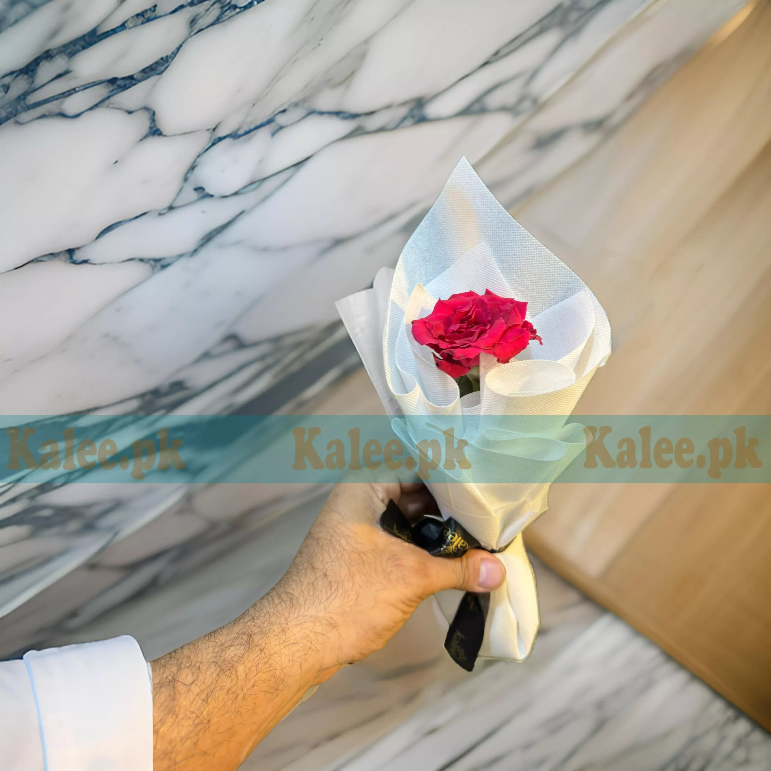 A single red rose with royal wrapping.