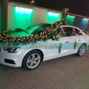 Lavish car adorned with tuberose and red-yellow roses decoration.