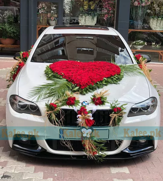A luxurious car adorned with stylish red roses.