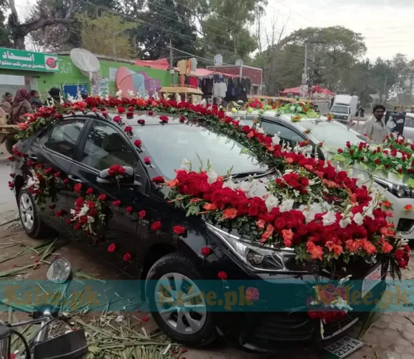 Car adorned with stylish decoration featuring glades and red roses.