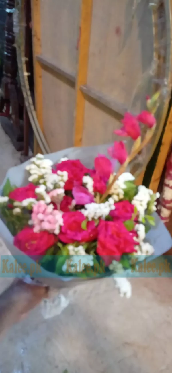 Bouquet of red roses and pink glades with tuberose and statice flowers