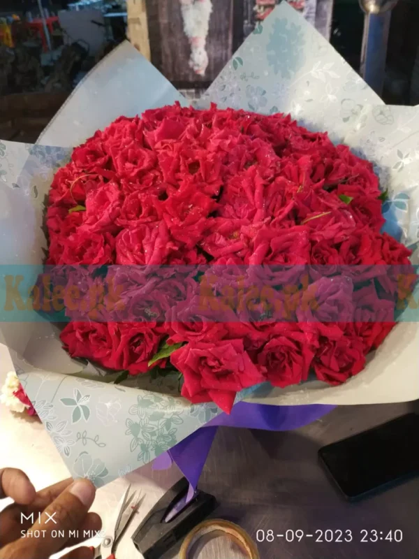 Bouquet of English red roses with fancy paper wrapping