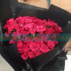 Fancy bouquet of black wrapped English red roses