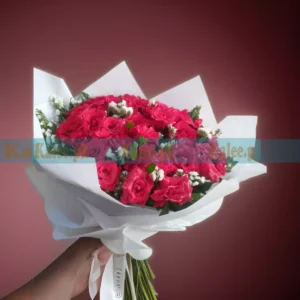 A bouquet featuring a combination of statice flowers and English red roses