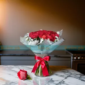 A bouquet showcasing a stylish arrangement of English red roses and statice flowers